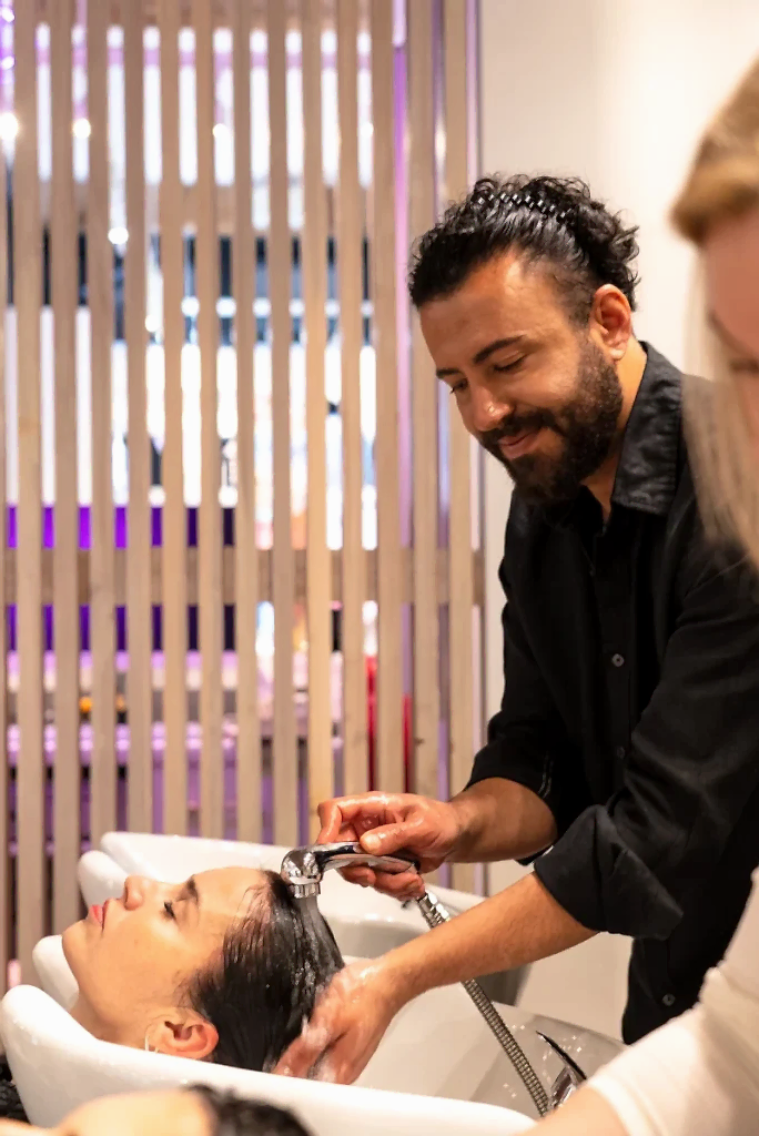 Stylist applying professional hair treatment product at Pink Lime Vancouver